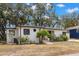 Beautiful single story home with mature shade trees and manicured front yard at 5415 Park Pl, Tampa, FL 33603