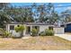 Charming home featuring an elegantly landscaped front yard and attached garage at 5415 Park Pl, Tampa, FL 33603