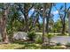 Well-maintained front yard with mature trees and landscaping, enhancing the property's curb appeal at 5415 Park Pl, Tampa, FL 33603