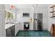 Modern kitchen with white cabinetry, stainless steel appliances, marble countertops, and green tile flooring at 5415 Park Pl, Tampa, FL 33603