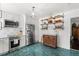 Bright kitchen featuring unique turquoise tile flooring and stainless steel appliances at 5415 Park Pl, Tampa, FL 33603