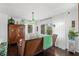 Bright living room featuring a wicker couch, hardwood floors, and sheer white curtains at 5415 Park Pl, Tampa, FL 33603