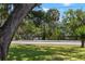 Street view of a home with a beautiful backdrop of mature trees and lush landscaping at 5415 Park Pl, Tampa, FL 33603