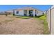 Corner view of backyard showing fenced yard, small patio, and artificial turf at 5464 Flint Hills Dr, Wimauma, FL 33598