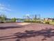 Community basketball court with a hoop, fenced area, and water views at 5464 Flint Hills Dr, Wimauma, FL 33598