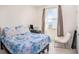 Well-lit bedroom with a comfortable bed and an accent chair near the window at 5464 Flint Hills Dr, Wimauma, FL 33598