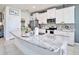 Bright kitchen with granite countertops, stainless steel appliances, and a large island at 5464 Flint Hills Dr, Wimauma, FL 33598