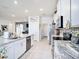 Bright kitchen with granite countertops, stainless steel appliances, and tiled floors at 5464 Flint Hills Dr, Wimauma, FL 33598