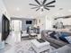 Comfortable living room with modern ceiling fan, TV and open to kitchen at 5464 Flint Hills Dr, Wimauma, FL 33598