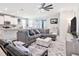 Cozy living room with modern fan, neutral colors, and an open floor plan at 5464 Flint Hills Dr, Wimauma, FL 33598