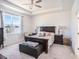 Serene main bedroom with tray ceiling, natural light, and a cozy ambiance at 5464 Flint Hills Dr, Wimauma, FL 33598