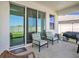 Covered patio featuring outdoor seating, a grill, and sliding glass doors to the home at 5464 Flint Hills Dr, Wimauma, FL 33598