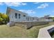 Backyard view featuring a white fence surrounding a well-maintained property and lush tropical foliage at 5717 Tybee Island Dr, Apollo Beach, FL 33572