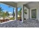 Beautiful covered porch offering a serene view of the landscaped front yard and neighborhood at 5717 Tybee Island Dr, Apollo Beach, FL 33572
