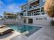Outdoor living with a pool, outdoor bar, and second-story balconies; perfect for entertaining at 5820 Balao S Way, St Pete Beach, FL 33706