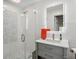 Modern bathroom featuring a glass-enclosed shower and sleek vanity with an illuminated mirror at 5820 Balao S Way, St Pete Beach, FL 33706