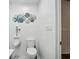 A modern bathroom with a toilet and urinal features stylish decor and clean, white tiling at 5820 Balao S Way, St Pete Beach, FL 33706