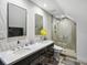 Modern bathroom with double sinks, sleek cabinetry, a glass shower, and stylish lighting for a spa-like experience at 5820 Balao S Way, St Pete Beach, FL 33706