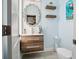 Stylish half bath with modern sink, decorative mirror, and sleek fixtures at 5820 Balao S Way, St Pete Beach, FL 33706