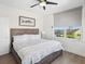 Charming bedroom featuring a ceiling fan, a large window, and comfortable nautical themed decor at 5820 Balao S Way, St Pete Beach, FL 33706