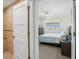 Comfortable bedroom with a glimpse into the tiled bathroom, features a view of the outdoor scenery at 5820 Balao S Way, St Pete Beach, FL 33706
