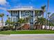 Striking modern home showcasing a unique circular window, sleek lines, and lush landscaping at 5820 Balao S Way, St Pete Beach, FL 33706