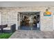 Open garage revealing an organized interior, with an exterior seating area and decorative signage at 5820 Balao S Way, St Pete Beach, FL 33706