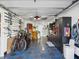 Well-organized garage with storage, bikes, tool cabinets, and unique flooring at 5820 Balao S Way, St Pete Beach, FL 33706