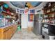 Unique garage with a custom ceiling mural, stainless steel refrigerator, and kitchenette area at 5820 Balao S Way, St Pete Beach, FL 33706