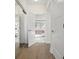 Hallway leads to the main bath with a sliding closet and wood grain floors at 5820 Balao S Way, St Pete Beach, FL 33706