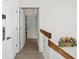 Hallway featuring modern doors, light wood floors, glass railing, and coastal decor at 5820 Balao S Way, St Pete Beach, FL 33706