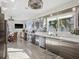 Modern kitchen with stainless steel appliances, custom cabinets, and a view of the lush tropical backyard at 5820 Balao S Way, St Pete Beach, FL 33706