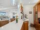Bright kitchen with white counters, pendant lights, a coffee station and open access to the living room at 5820 Balao S Way, St Pete Beach, FL 33706