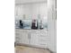 Contemporary kitchen with white cabinets, sleek countertops, and stainless steel appliances at 5820 Balao S Way, St Pete Beach, FL 33706