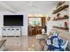 Inviting living room with casual seating, a large TV, and an open bar area for entertaining at 5820 Balao S Way, St Pete Beach, FL 33706