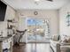 Bright living room with tile floors, a modern ceiling fan, and sliding glass doors to the pool area at 5820 Balao S Way, St Pete Beach, FL 33706