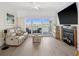 Bright living room featuring water views, a modern fireplace, and stylish, comfortable furnishings at 5820 Balao S Way, St Pete Beach, FL 33706