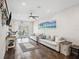 A spacious living room featuring tile floors and comfortable couches with beach-themed decorations at 5820 Balao S Way, St Pete Beach, FL 33706