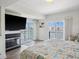 Bright bedroom features waterfront views, a modern fireplace, and balcony access at 5820 Balao S Way, St Pete Beach, FL 33706