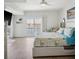 Light and airy main bedroom with water views, balcony access, and ceiling fan at 5820 Balao S Way, St Pete Beach, FL 33706