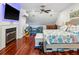 Bright bedroom with hardwood floors, a fireplace, a TV, and a cozy sitting area for relaxation at 5820 Balao S Way, St Pete Beach, FL 33706