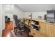 A well-organized home office features a wooden desk and ample storage within the sloped ceiling space at 5820 Balao S Way, St Pete Beach, FL 33706