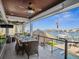 Covered outdoor patio with dining area and comfortable seating overlooking the beautiful waterfront at 5820 Balao S Way, St Pete Beach, FL 33706