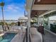 Outdoor patio with dining area, grill, ceiling fans, and a view of the waterfront at 5820 Balao S Way, St Pete Beach, FL 33706