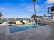 Waterfront pool with lounge seating and boat dock access on a sunny day at 5820 Balao S Way, St Pete Beach, FL 33706