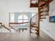 Unique spiral staircase with a round window bringing natural light to the home's interior at 5820 Balao S Way, St Pete Beach, FL 33706