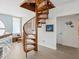 Unique spiral staircase with a round window bringing natural light to the home's interior at 5820 Balao S Way, St Pete Beach, FL 33706