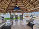 Waterfront tiki bar with counter seating, lounge chairs, and a mounted sailfish decoration overlooking the waterway at 5820 Balao S Way, St Pete Beach, FL 33706