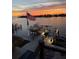 Beautiful waterfront home featuring a boat lift and dock with a stunning sunset view at 5820 Balao S Way, St Pete Beach, FL 33706