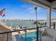 Relaxing waterfront view with a private pool, dock, and lush tropical landscaping at 5820 Balao S Way, St Pete Beach, FL 33706